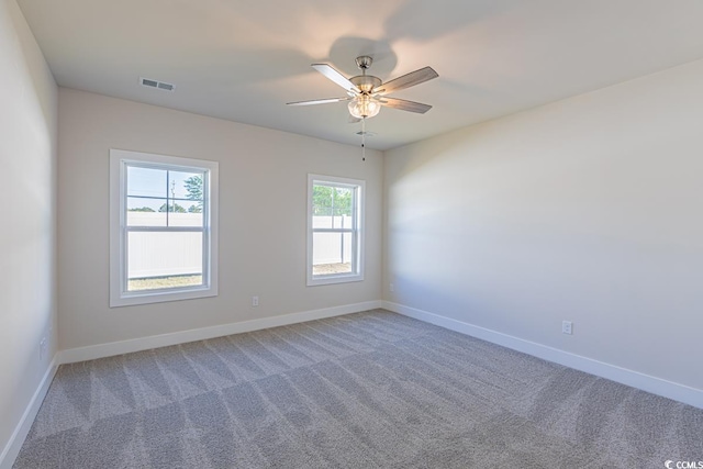 carpeted empty room featuring ceiling fan