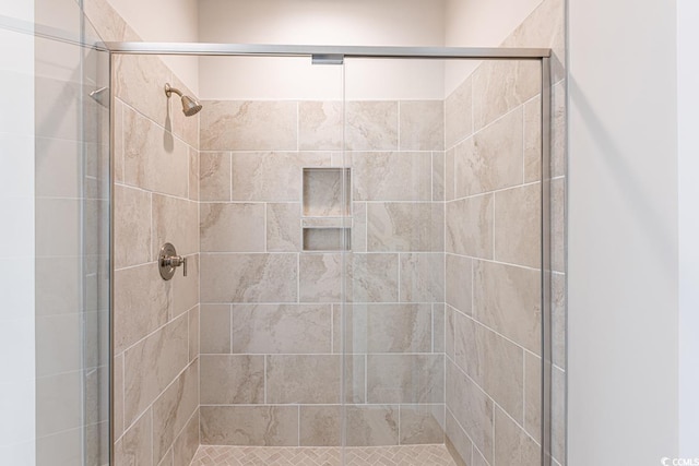 bathroom featuring a shower with door