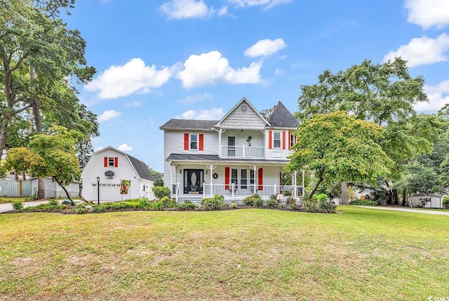 view of front of house featuring a garage, a front lawn, and a porch