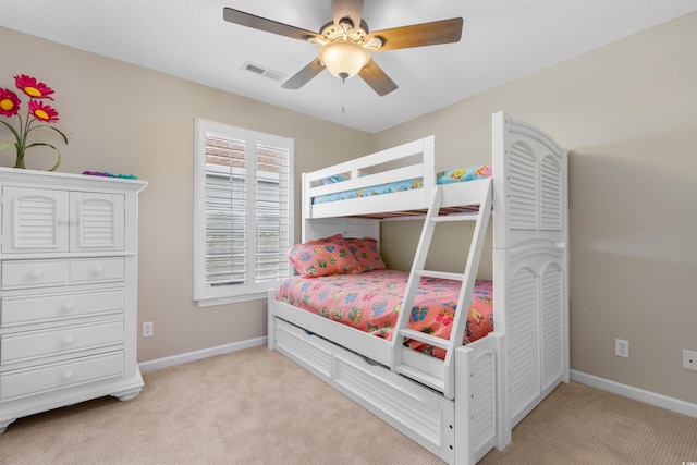 bedroom with ceiling fan and light colored carpet