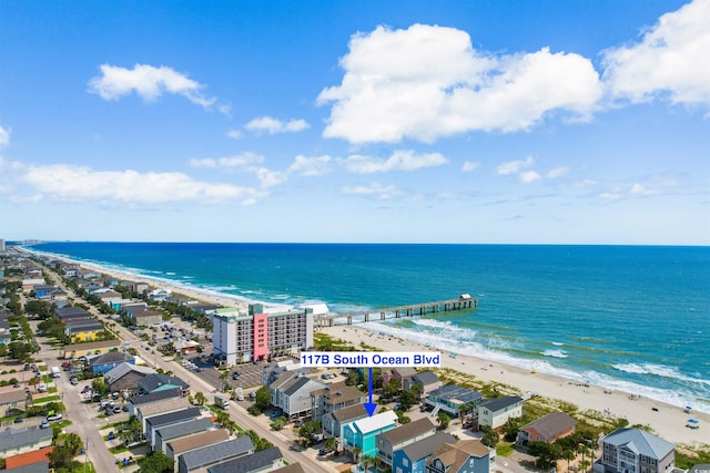 bird's eye view featuring a water view and a beach view