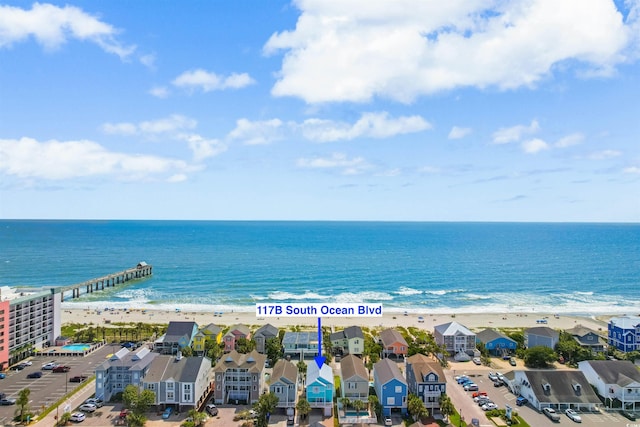 drone / aerial view with a water view and a view of the beach