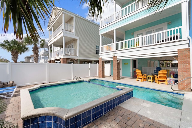 view of pool with a patio and a hot tub