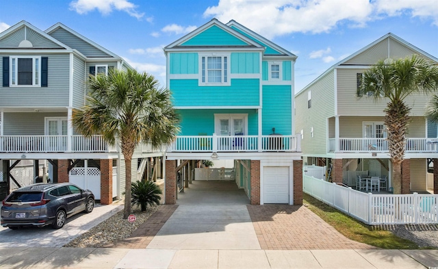 117B Ocean Blvd S, Surfside Beach, SC 29575 - raised beach house featuring driveway, a carport, board and batten siding, and a garage