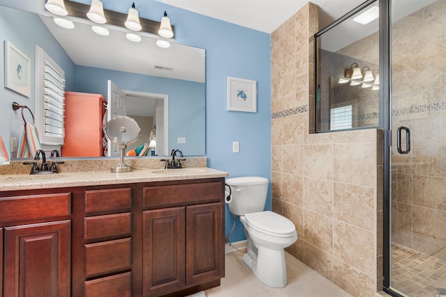 bathroom with vanity, toilet, an enclosed shower, and tile patterned floors