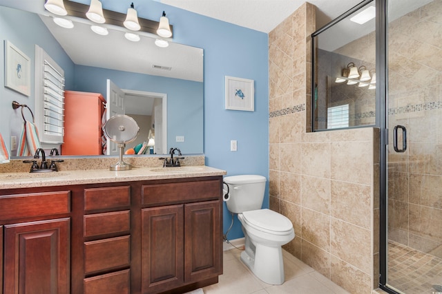 117B Ocean Blvd S, Surfside Beach, SC 29575 - bathroom featuring tile patterned flooring, a sink, a shower stall, and toilet