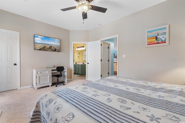 carpeted bedroom featuring ceiling fan and ensuite bath