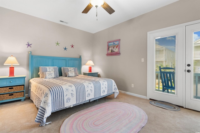 carpeted bedroom with access to outside, multiple windows, and ceiling fan