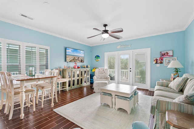 living room with ceiling fan, dark wood-type flooring, and crown molding