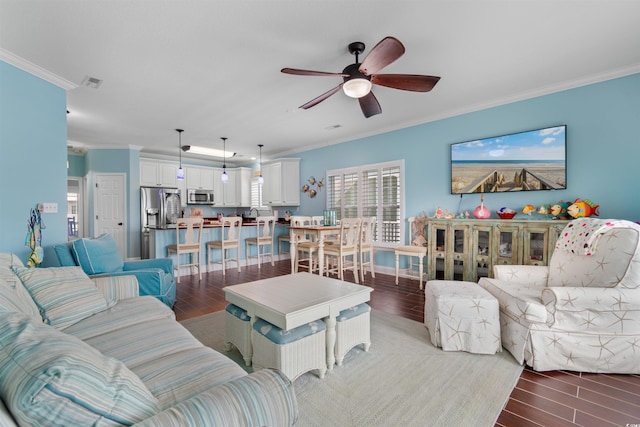 living room featuring wood-type flooring, ceiling fan, and crown molding