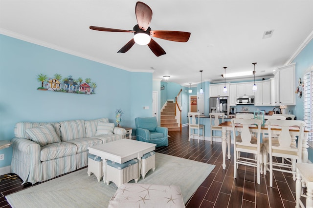 living room with ceiling fan, ornamental molding, and dark wood-type flooring