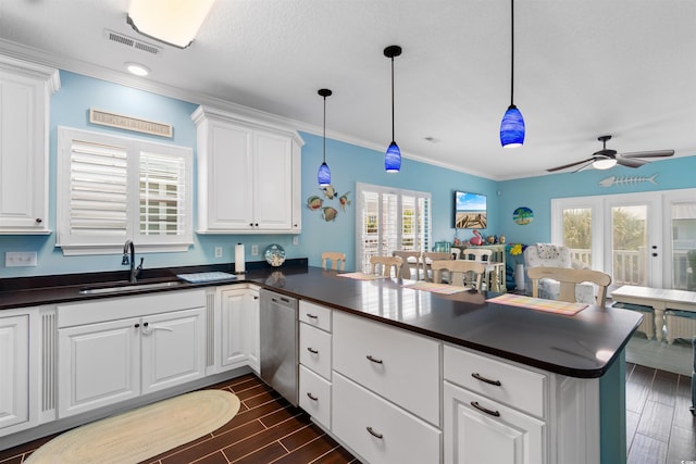 117B Ocean Blvd S, Surfside Beach, SC 29575 - kitchen featuring dark countertops, a sink, dishwasher, a peninsula, and visible vents
