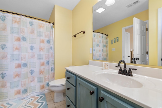 bathroom featuring tile patterned floors, a shower with curtain, vanity, and toilet