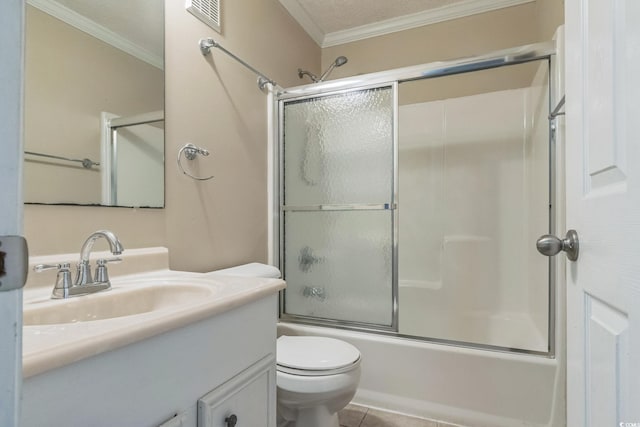 full bathroom with tile patterned flooring, ornamental molding, vanity, enclosed tub / shower combo, and toilet