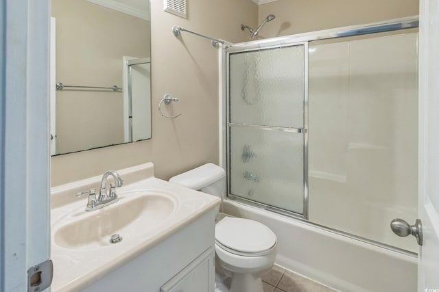 full bathroom with combined bath / shower with glass door, tile patterned floors, crown molding, vanity, and toilet