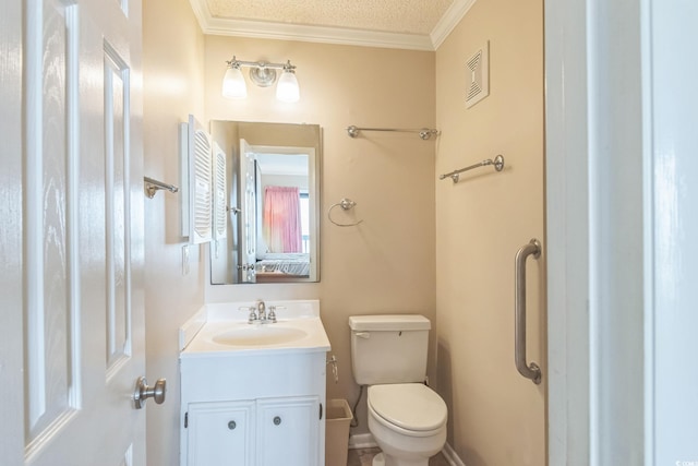 bathroom with ornamental molding, vanity, toilet, and a textured ceiling