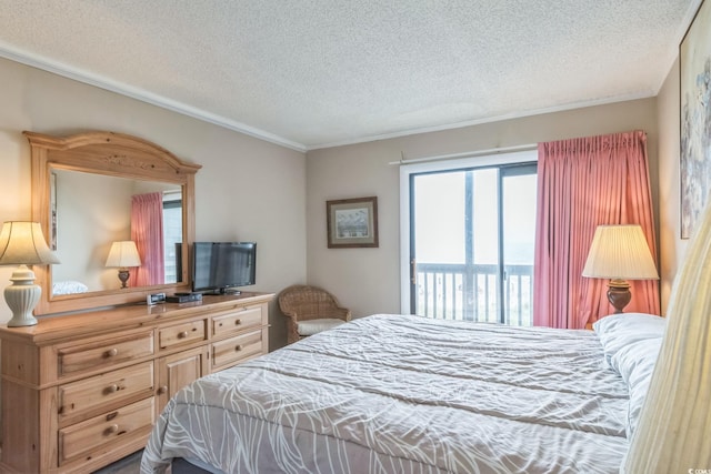 bedroom featuring a textured ceiling, access to outside, and ornamental molding