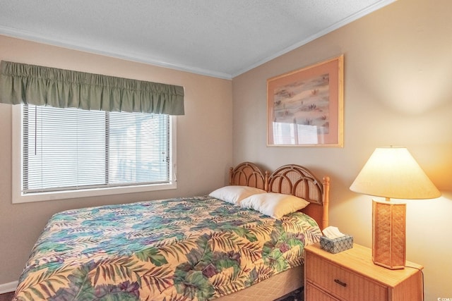 bedroom with ornamental molding and a textured ceiling