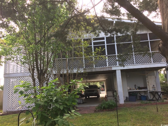 back of property with a patio area and a yard