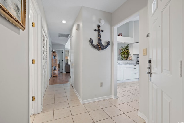 hall with light tile patterned floors