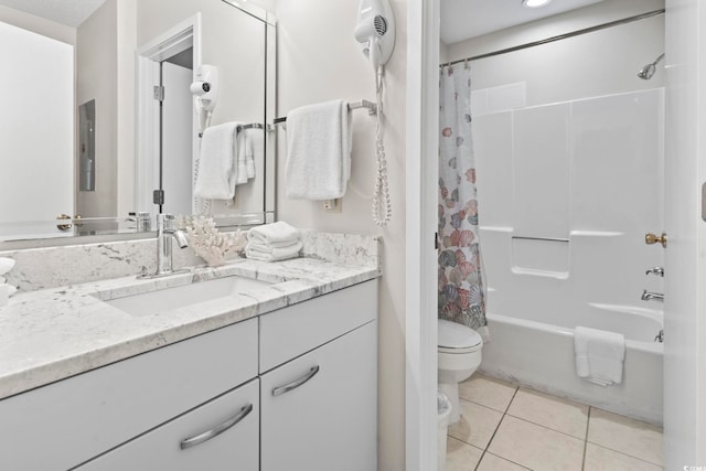 full bathroom featuring tile patterned floors, shower / bath combo with shower curtain, vanity, and toilet