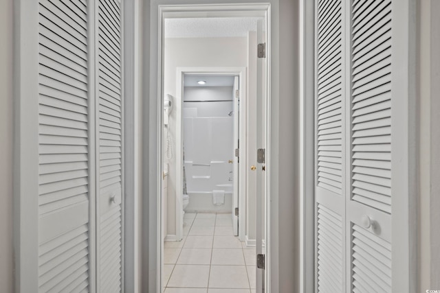 hall featuring light tile patterned floors