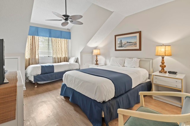 bedroom with hardwood / wood-style floors, ceiling fan, and lofted ceiling