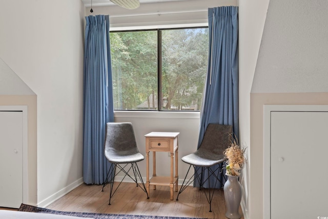 living area with hardwood / wood-style floors and a wealth of natural light