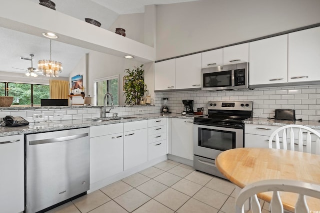 kitchen featuring stainless steel appliances, white cabinetry, and sink