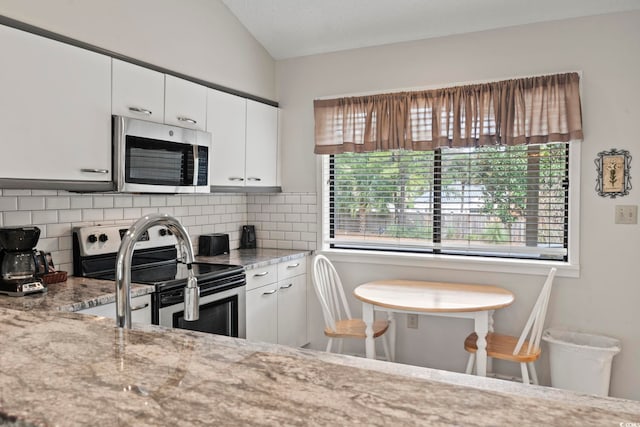 kitchen featuring white cabinets, stainless steel appliances, and plenty of natural light