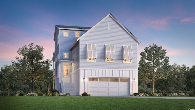 view of front of home with a yard and a garage