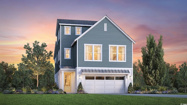 view of front property with a yard and a garage