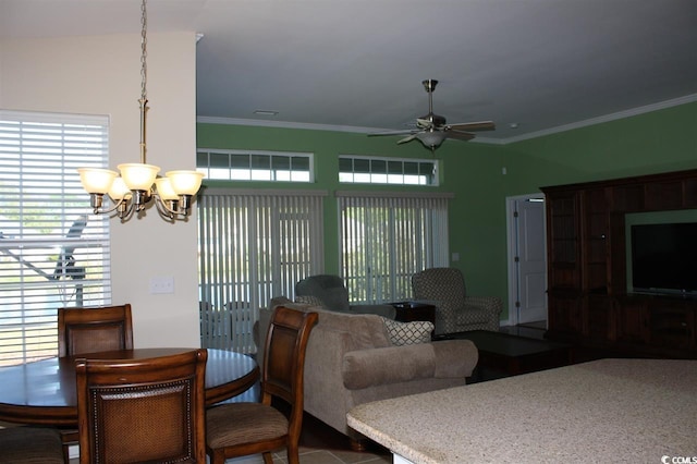 dining area featuring ceiling fan with notable chandelier, vaulted ceiling, crown molding, and a healthy amount of sunlight