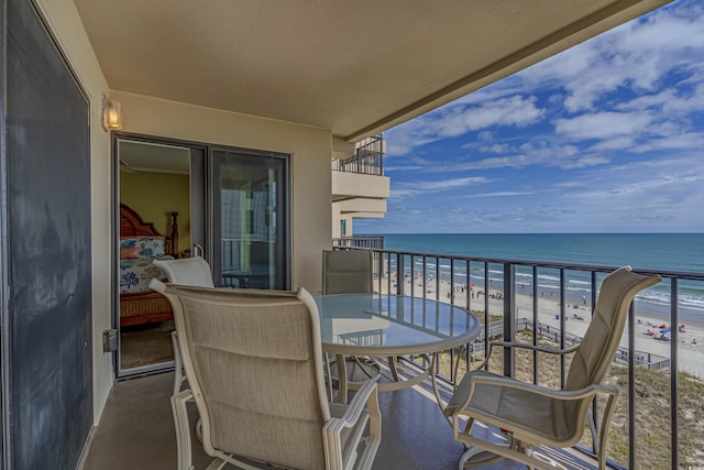 balcony with a beach view and a water view