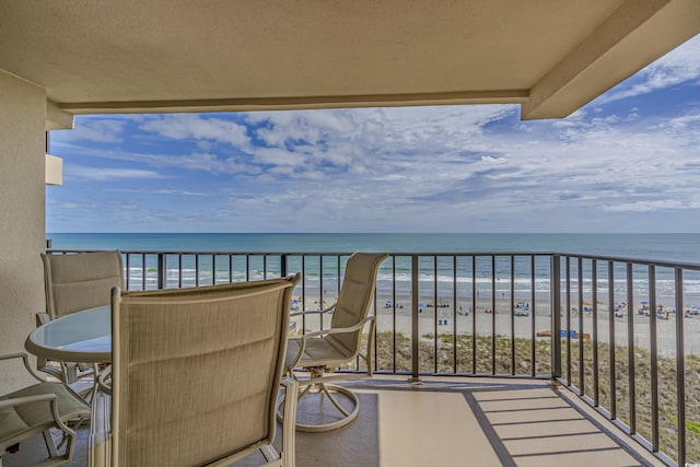 balcony featuring a water view and a view of the beach