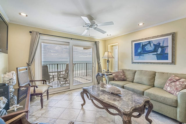 tiled living room featuring ornamental molding, ceiling fan, and a water view