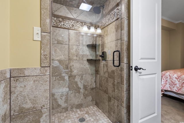 bathroom with crown molding and walk in shower