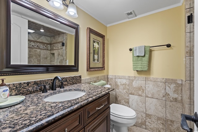 bathroom featuring toilet, an enclosed shower, crown molding, tile walls, and vanity