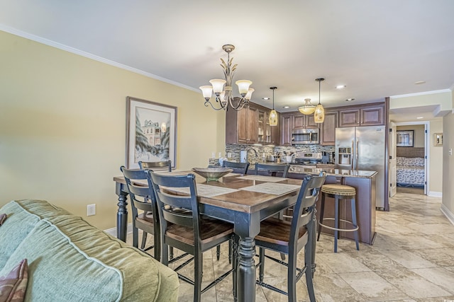 dining room with a notable chandelier and ornamental molding