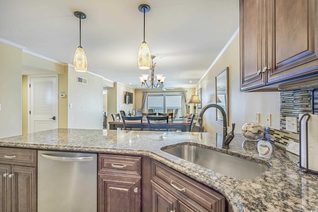 kitchen featuring stone counters, decorative light fixtures, dishwasher, sink, and an inviting chandelier