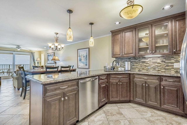 kitchen with dark brown cabinetry, appliances with stainless steel finishes, decorative light fixtures, and kitchen peninsula