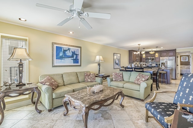 living room featuring crown molding and ceiling fan with notable chandelier