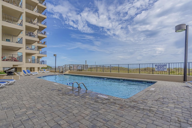 view of pool featuring a patio