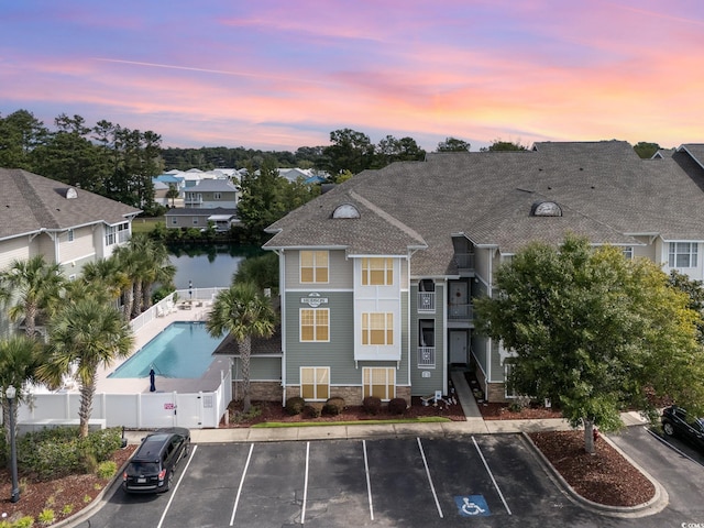 outdoor building at dusk featuring a water view