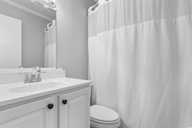 bathroom featuring walk in shower, ornamental molding, vanity, and toilet