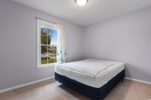 carpeted bedroom featuring a textured ceiling