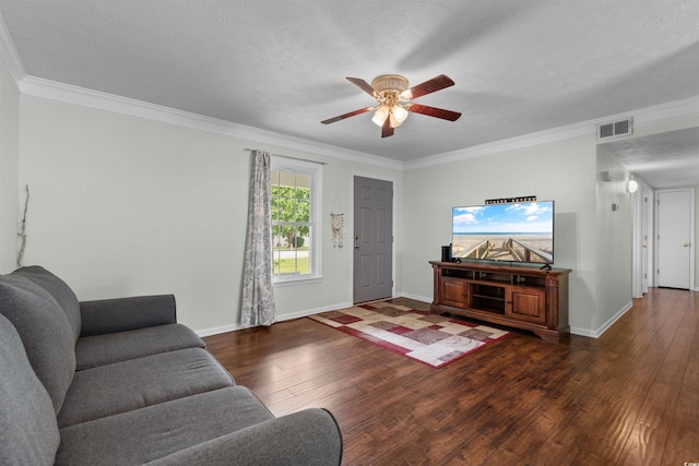 living room with a textured ceiling, crown molding, dark wood-type flooring, and ceiling fan