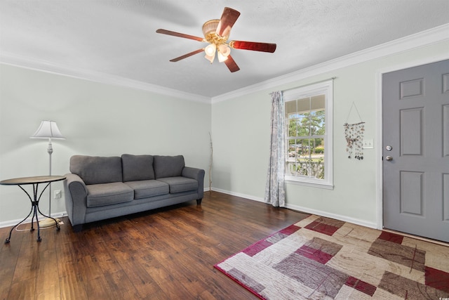 living room featuring ceiling fan, ornamental molding, a textured ceiling, and dark wood-type flooring