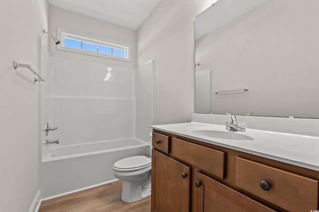 full bathroom with vanity, bathing tub / shower combination, wood finished floors, and toilet