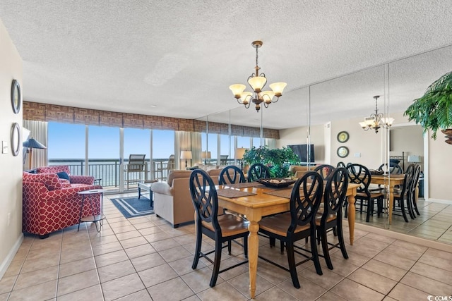 tiled dining room featuring a textured ceiling and a chandelier